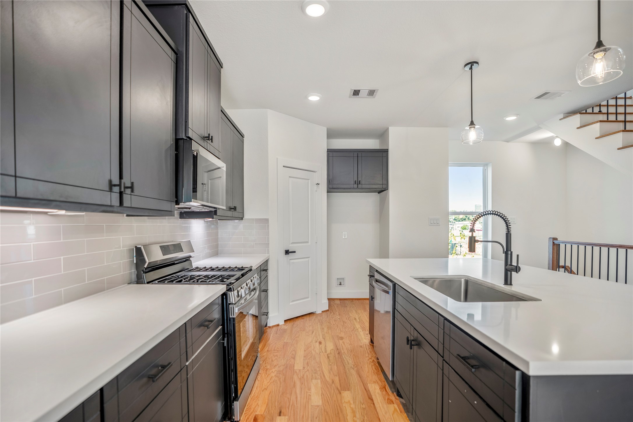 6324 Del Rio Street Houston, TX 77021 - Photo 12 of 50 a kitchen that has a lot of cabinets in it and wooden floors