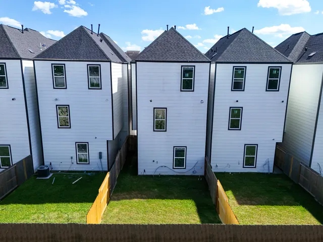 a view of a hallway with wooden floor and stairs