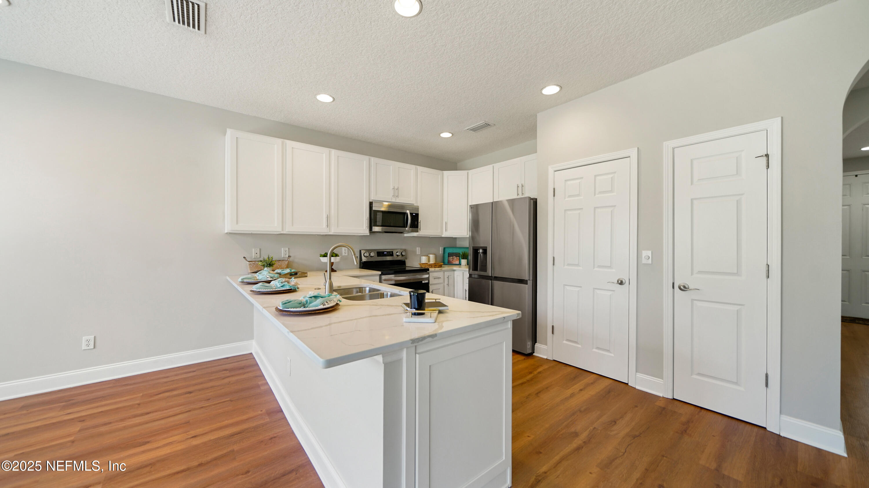 18 Amistad Drive St. Augustine, FL 32086 - Photo 11 of 36 a kitchen with stainless steel appliances granite countertop a sink stove and wooden floor