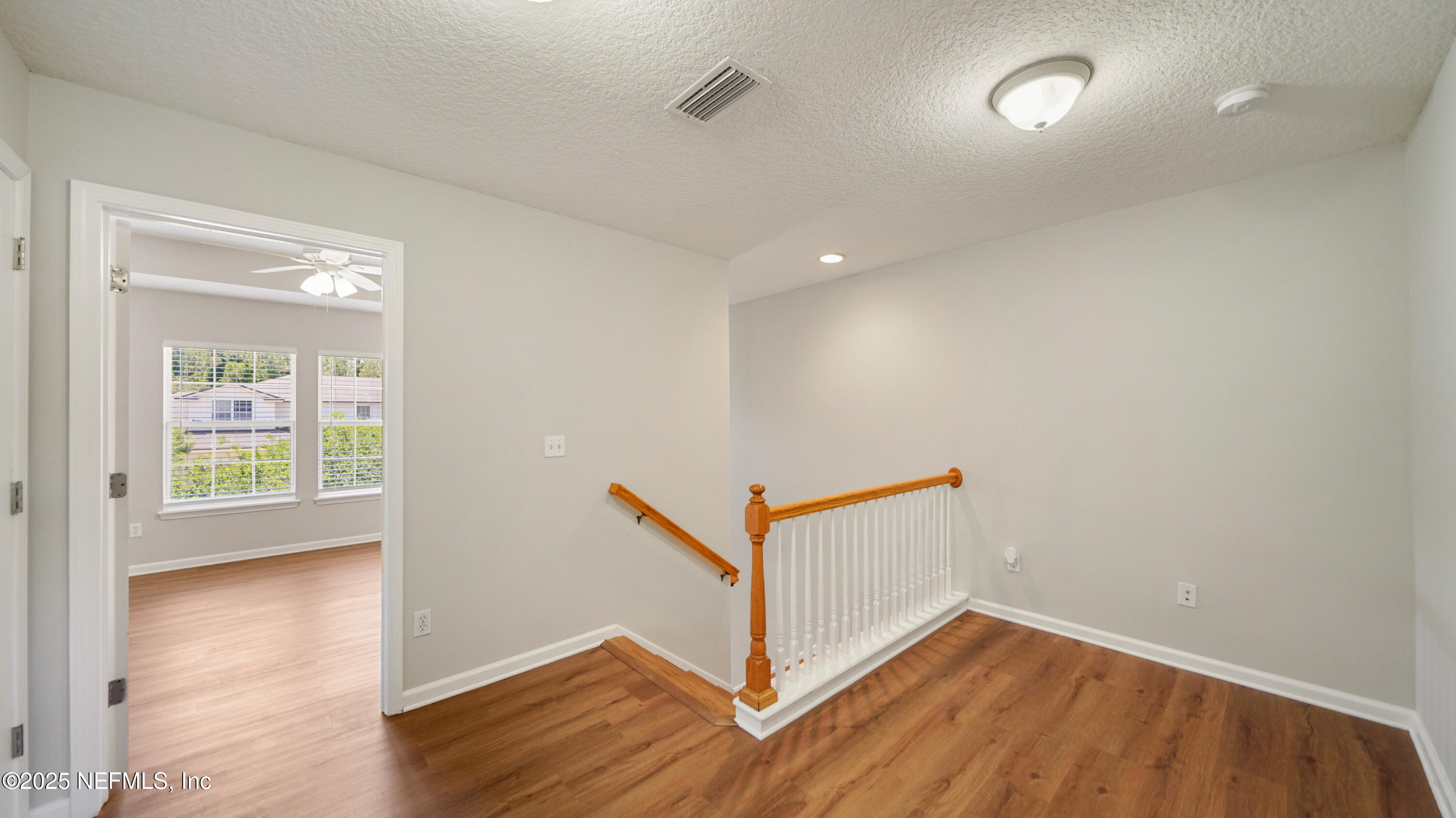 18 Amistad Drive St. Augustine, FL 32086 - Photo 13 of 36 wooden floor in an empty room with a window