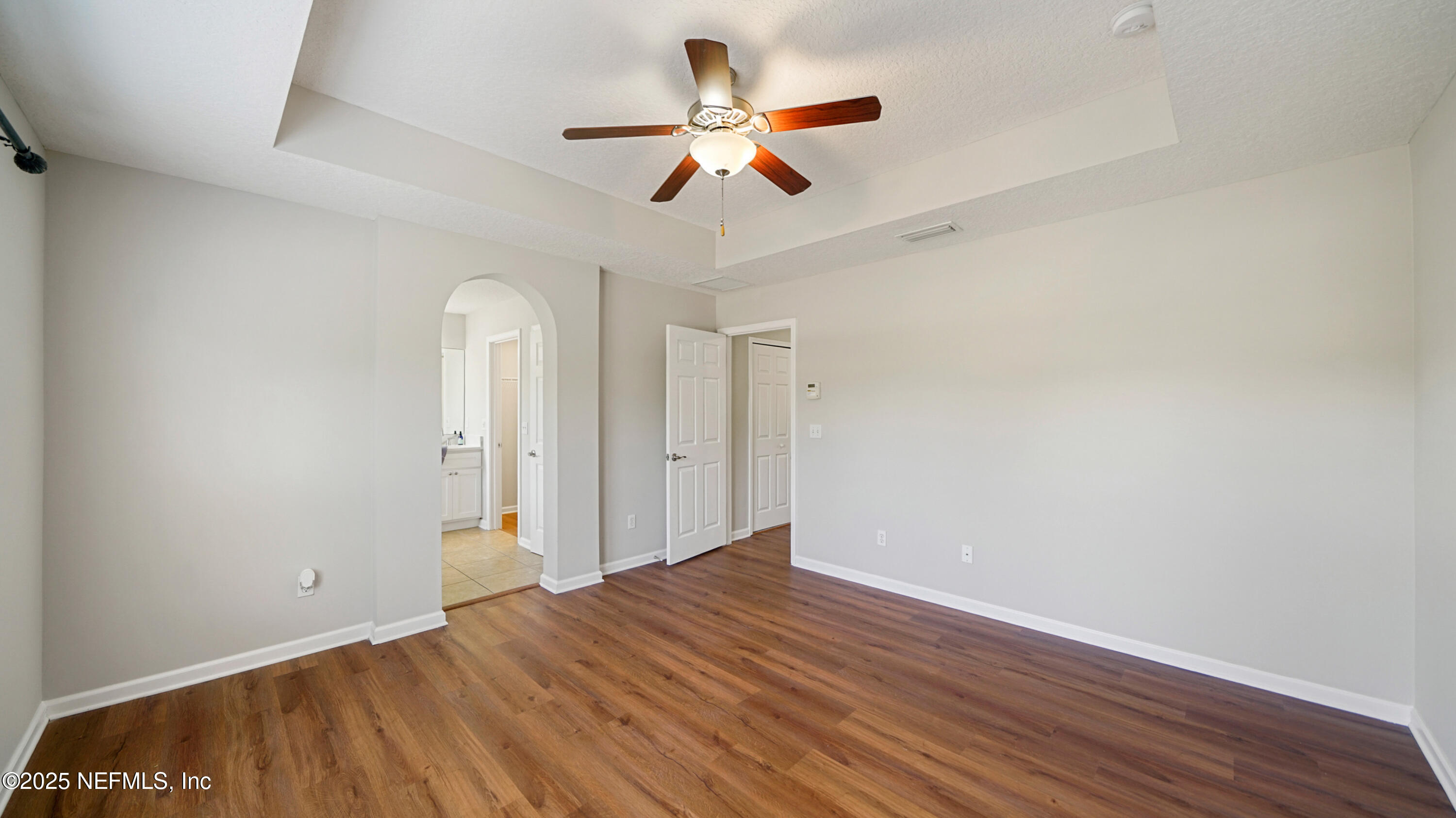 18 Amistad Drive St. Augustine, FL 32086 - Photo 16 of 36 an empty room with wooden floor ceiling fan and windows