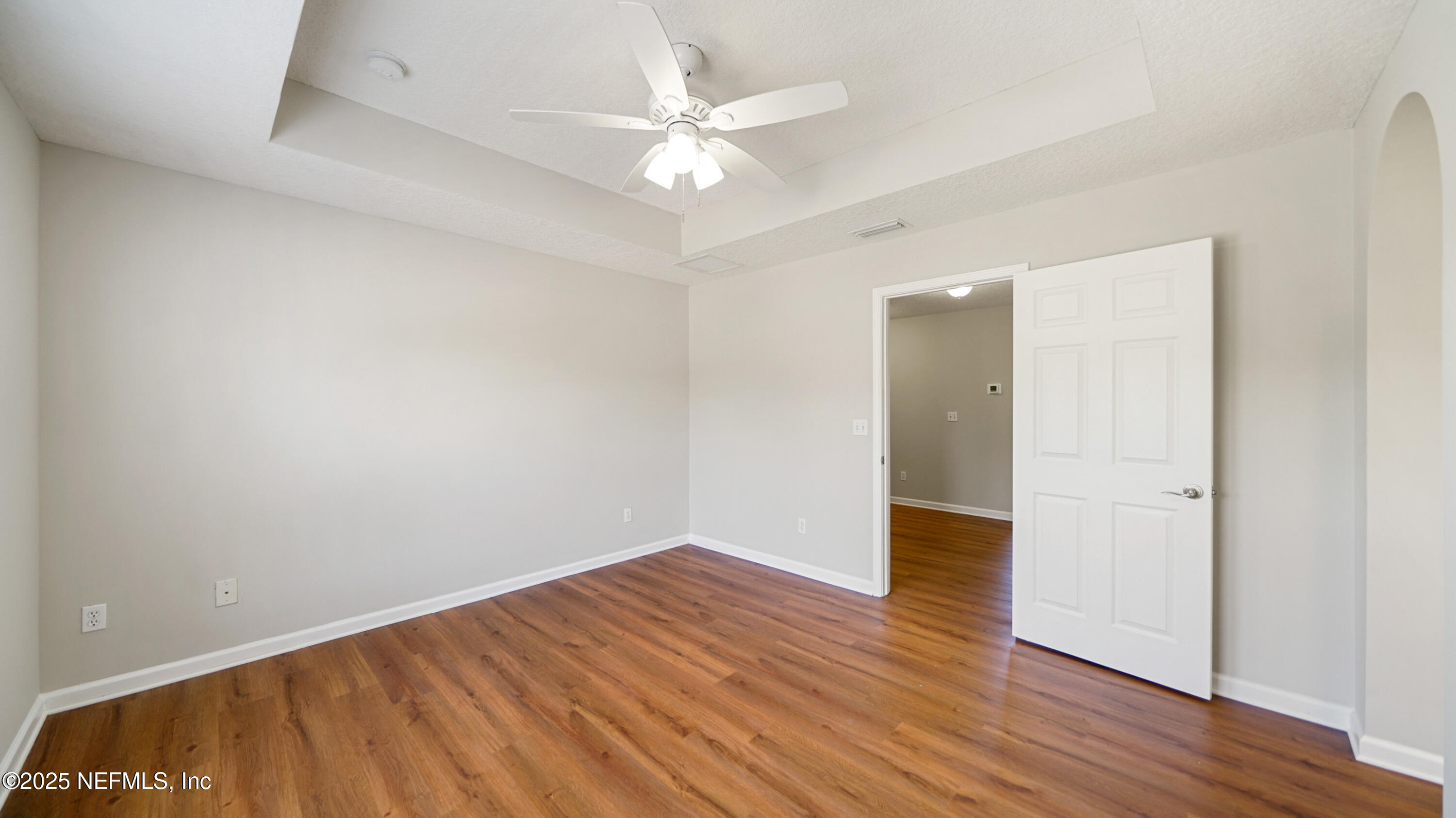 18 Amistad Drive St. Augustine, FL 32086 - Photo 22 of 36 an empty room with wooden floor and fan