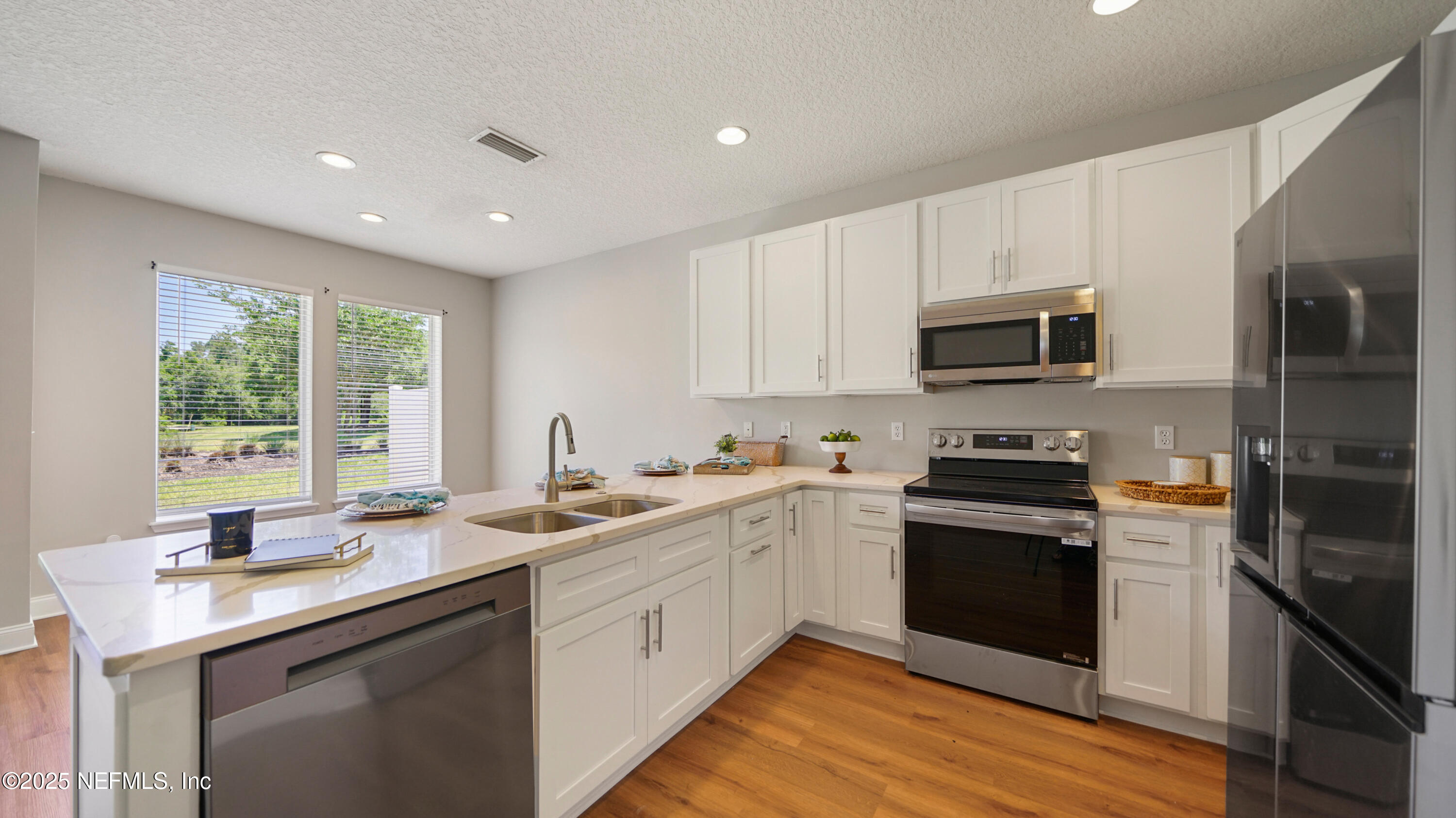 18 Amistad Drive St. Augustine, FL 32086 - Photo 6 of 36 a kitchen with a sink stove top oven and refrigerator