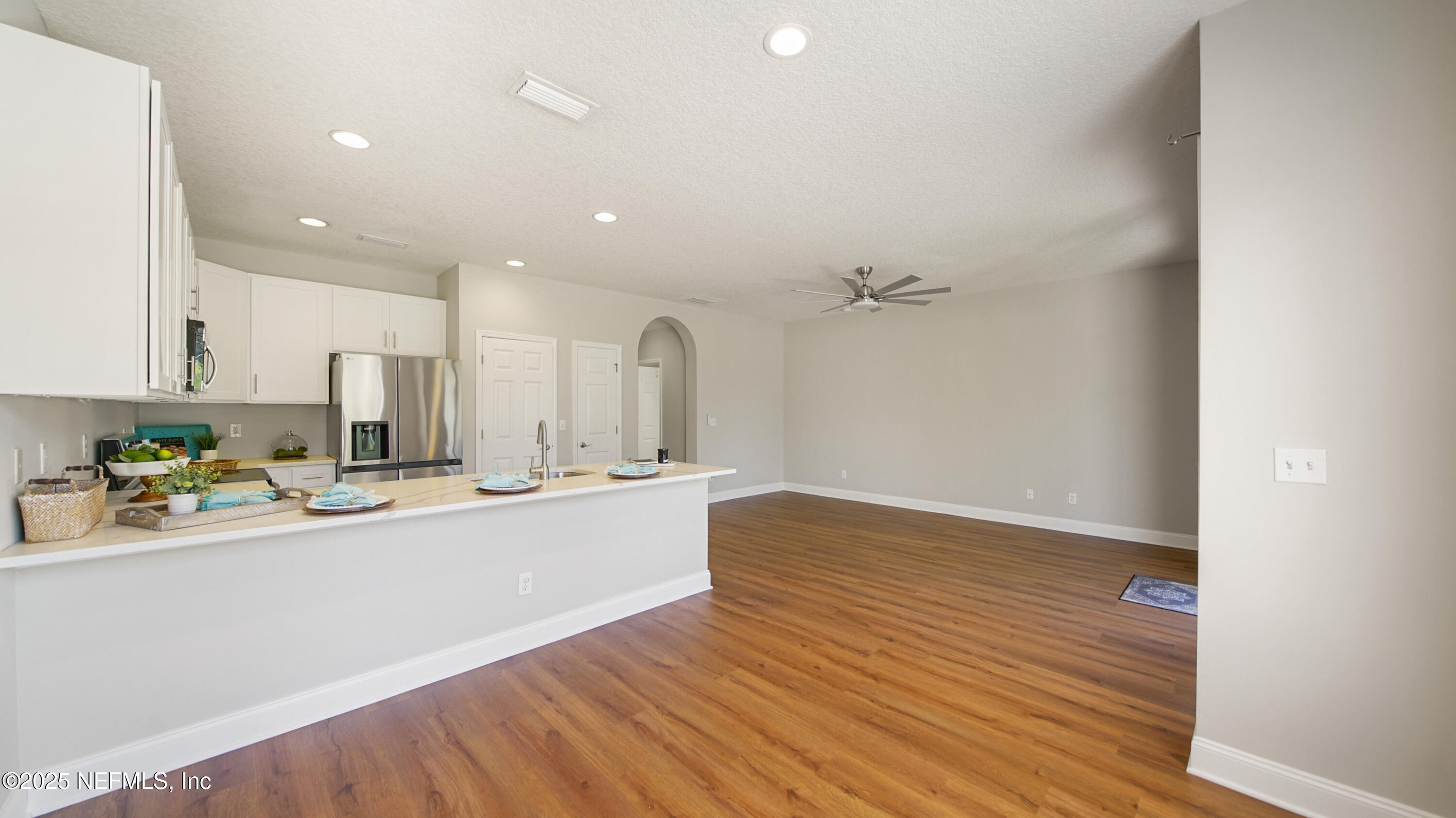 18 Amistad Drive St. Augustine, FL 32086 - Photo 8 of 36 a view of a kitchen with kitchen island a sink wooden floor and stainless steel appliances