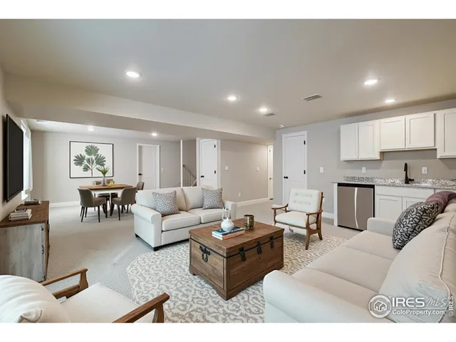 a view of kitchen with refrigerator and white cabinets