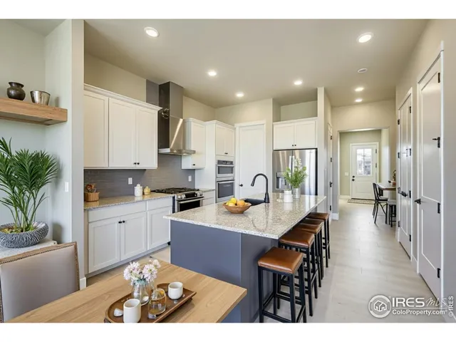 a kitchen with stainless steel appliances kitchen island granite countertop a sink and cabinets