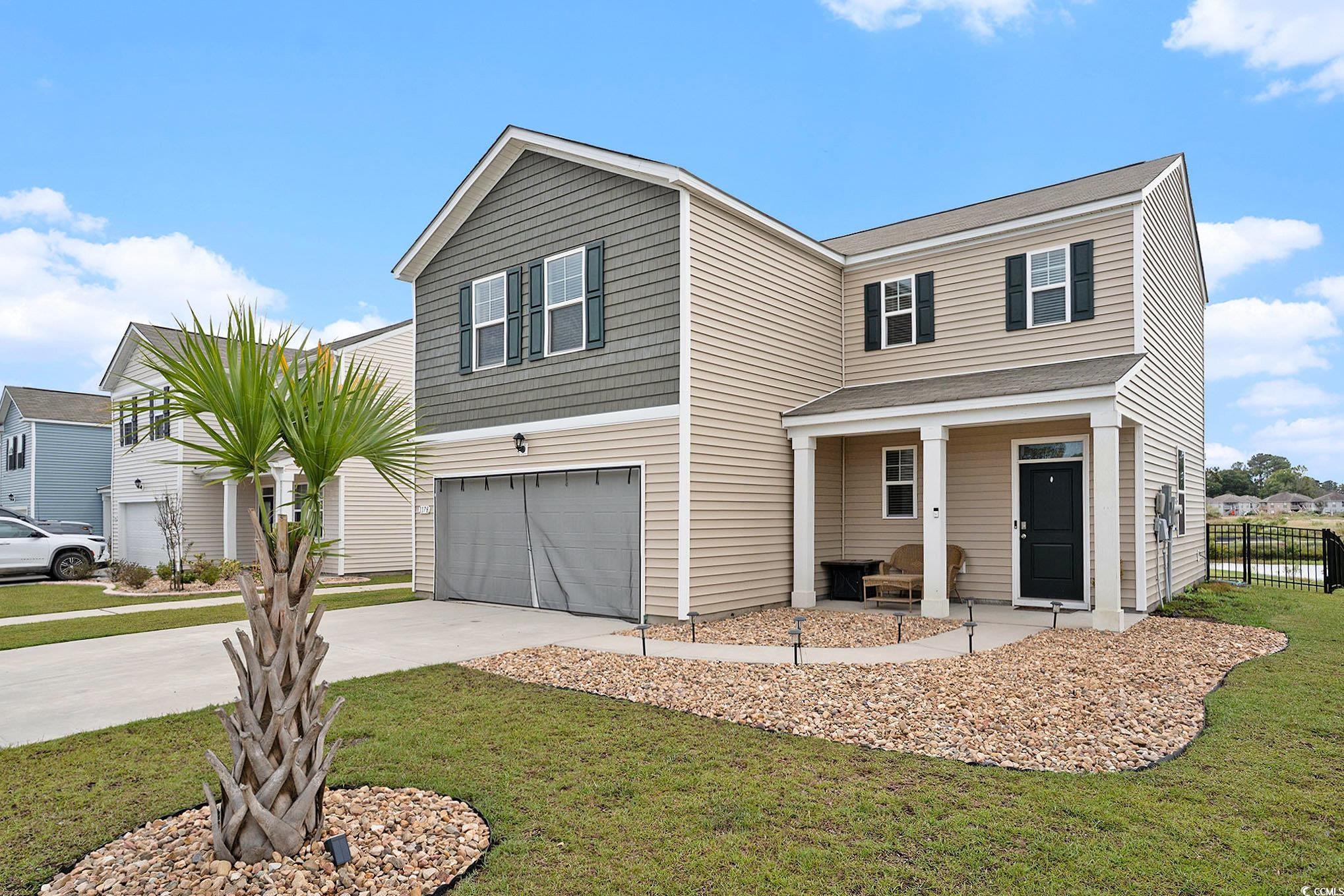 1178 Sennema Circle Myrtle Beach, SC 29588 - Photo 2 of 31 Traditional-style home with driveway, an attached garage, and covered porch