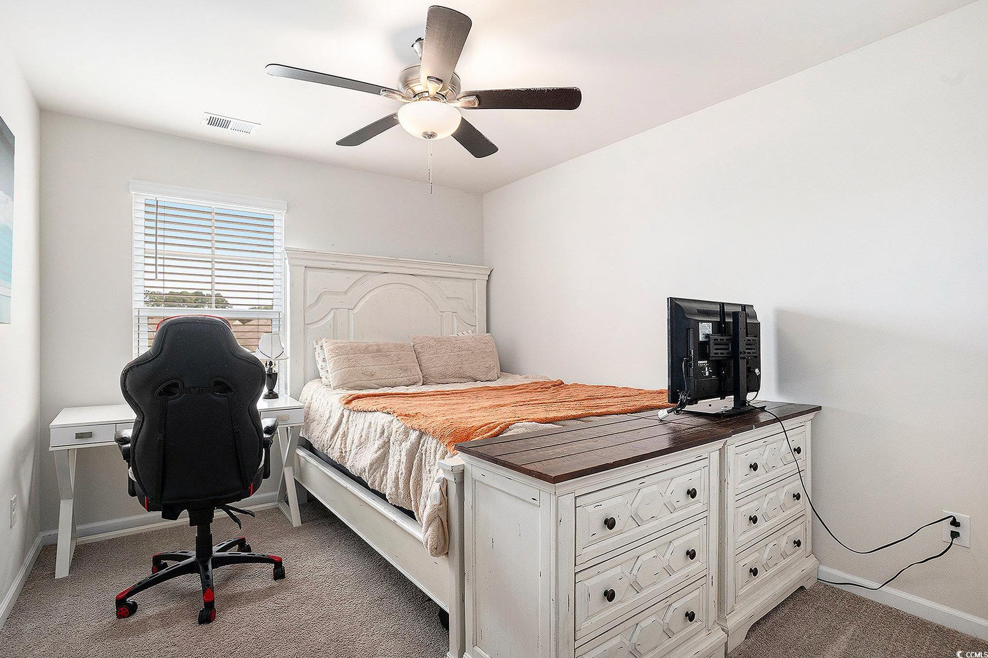 1178 Sennema Circle Myrtle Beach, SC 29588 - Photo 21 of 31 Bedroom with light carpet, ceiling fan, and a desk