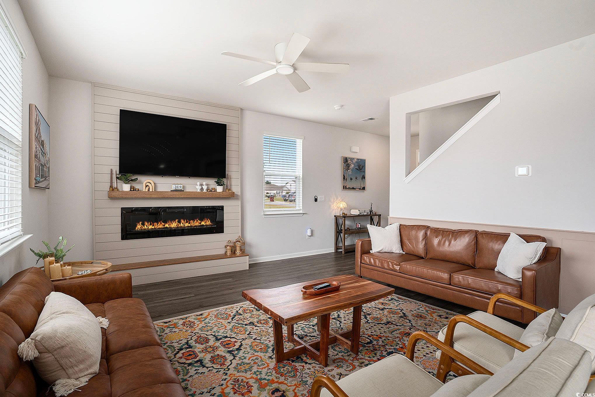1178 Sennema Circle Myrtle Beach, SC 29588 - Photo 7 of 31 Living area with ceiling fan, wood finished floors, and a large fireplace