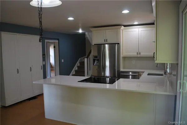 a kitchen with a refrigerator and a sink