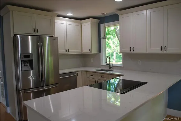 a kitchen with a white cabinets and stainless steel appliances