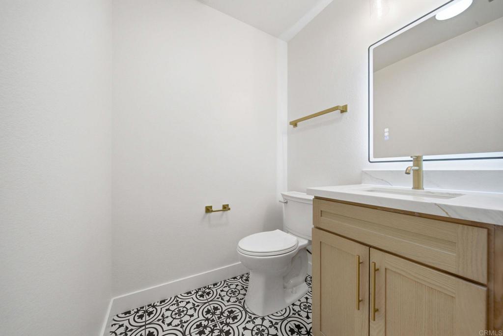 6757 Friars Road, Unit 36 San Diego, CA 92108 - Photo 12 of 23 a bathroom with a sink a toilet and a mirror