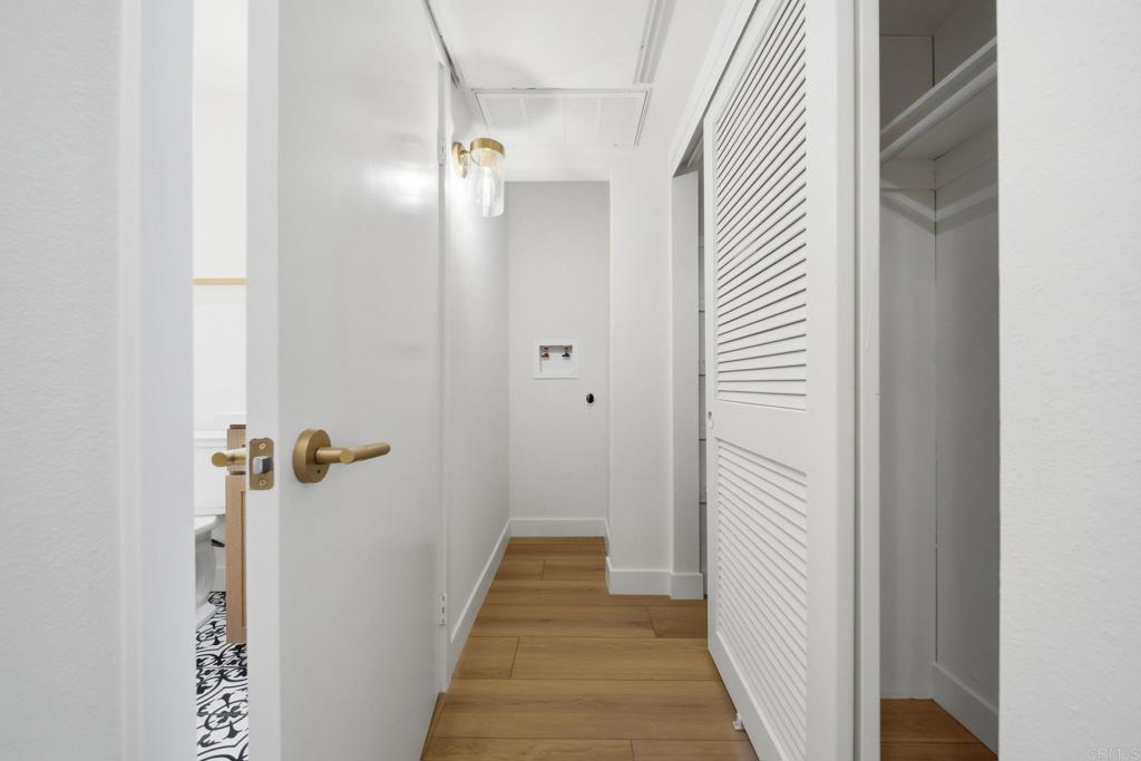 6757 Friars Road, Unit 36 San Diego, CA 92108 - Photo 13 of 23 a view of a hallway with wooden floor and closet