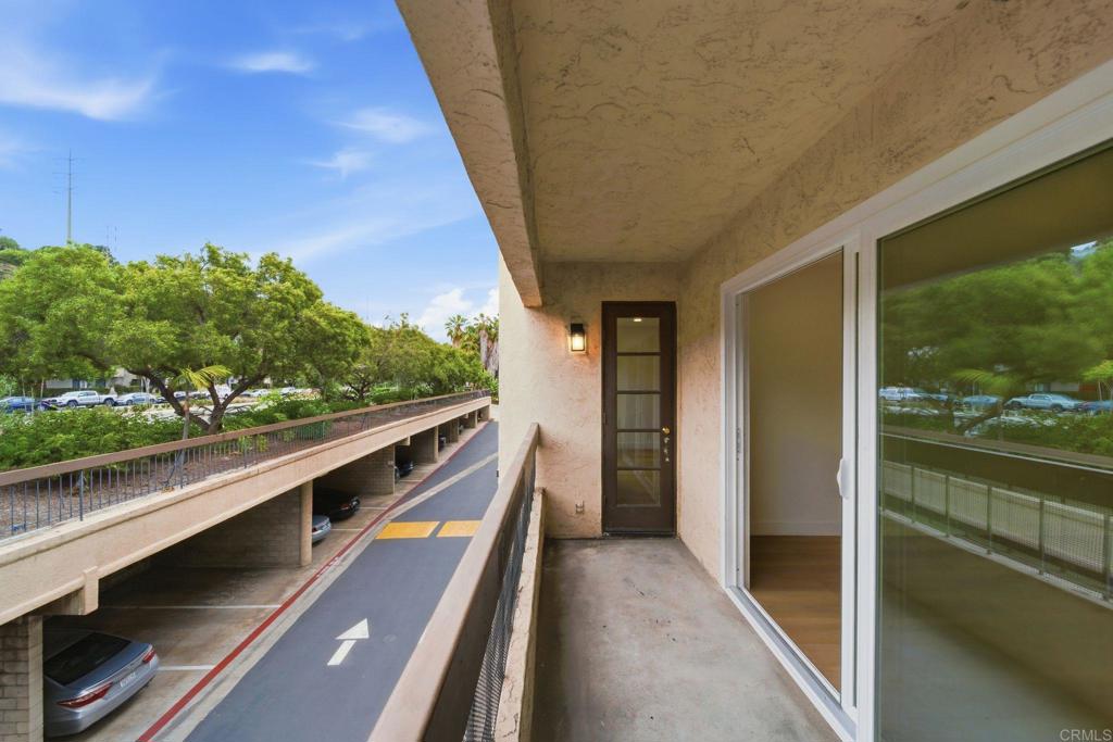 6757 Friars Road, Unit 36 San Diego, CA 92108 - Photo 15 of 23 a view of balcony with two large trees and outdoor seating
