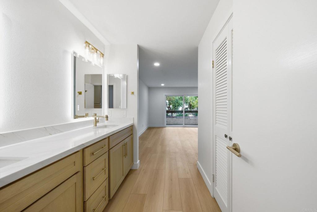 6757 Friars Road, Unit 36 San Diego, CA 92108 - Photo 5 of 23 a en suite bathroom with a granite countertop sink and a mirror