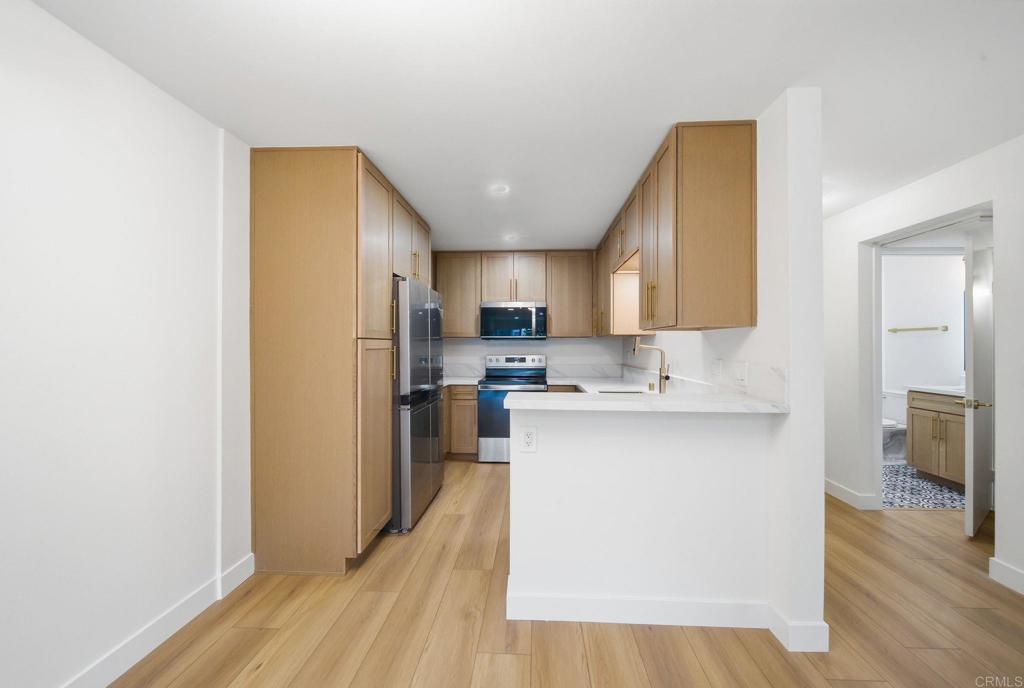6757 Friars Road, Unit 36 San Diego, CA 92108 - Photo 9 of 23 a kitchen with a sink cabinets and wooden floor