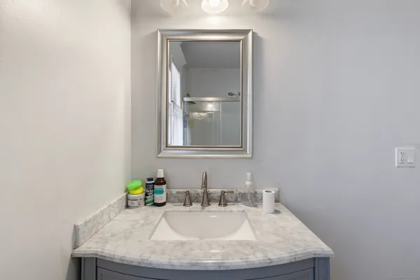 a bathroom with a glass shower door