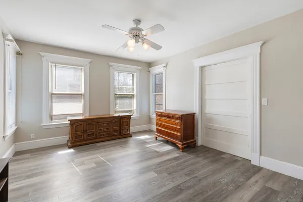 a spacious bedroom with a bed and a window