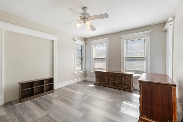 a view of an empty room with wooden floor