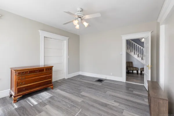 an empty room with windows and closet