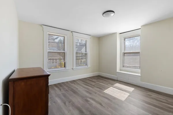 an empty room with windows and closet