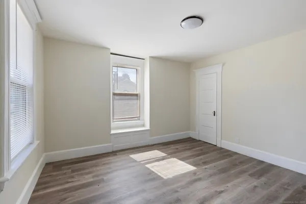 an empty room with windows and closet