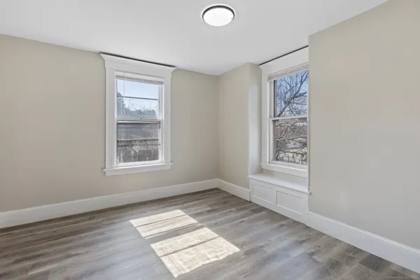 a view of room with wooden floor and window