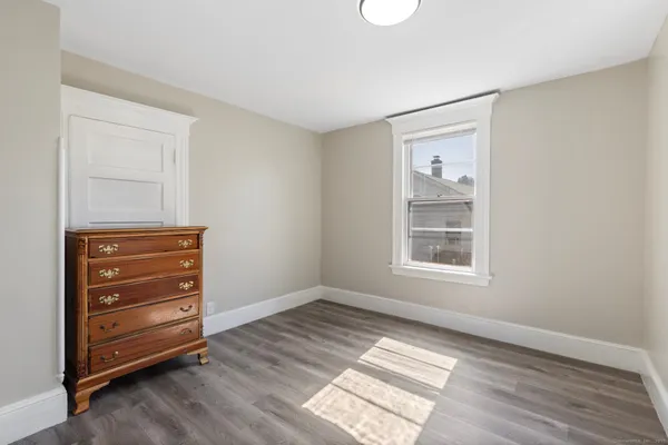 a view of an empty room and wooden floor