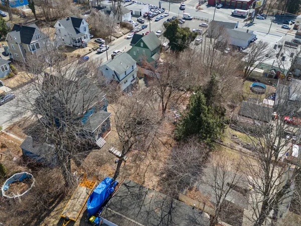 an aerial view of a house with a yard