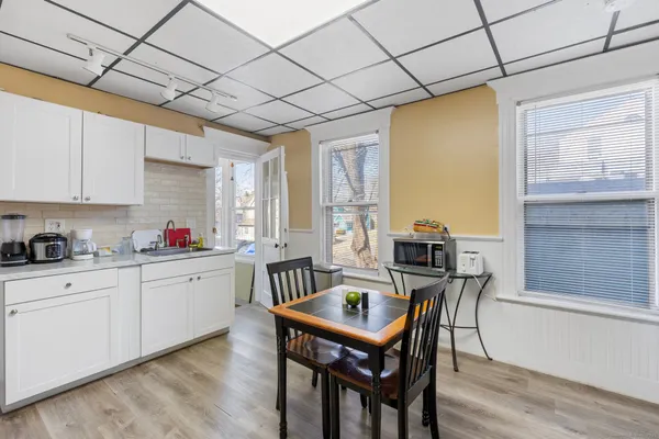 a kitchen with granite countertop a sink appliances and cabinets