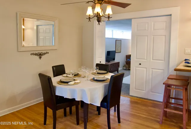 a view of a dining room with furniture and wooden floor