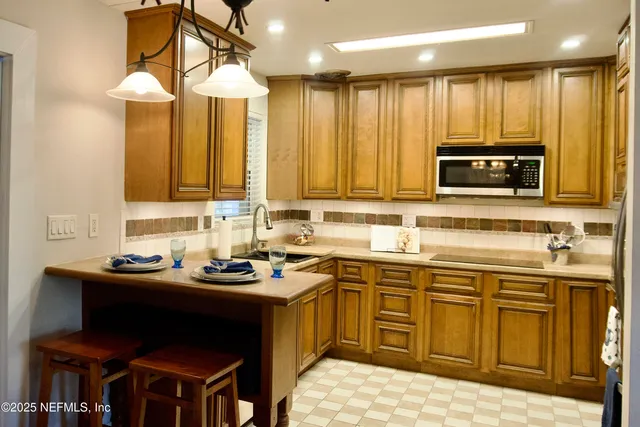 a kitchen with a sink and a stove top oven