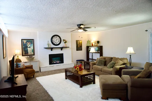 a living room with furniture a clock and a fireplace