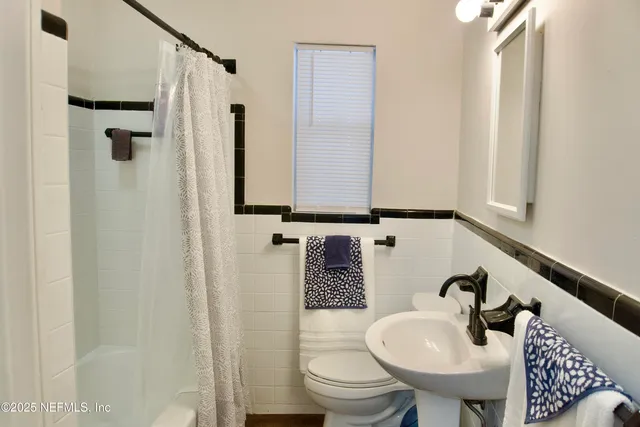 a bathroom with a sink toilet and mirror