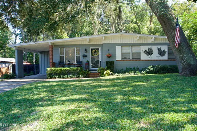 a front view of a house with a garden and porch