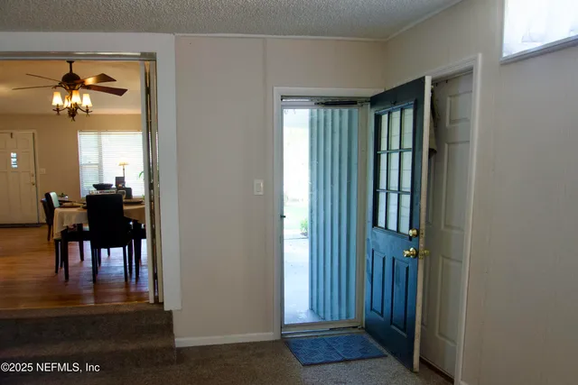 a view of a livingroom with a dining table and chairs