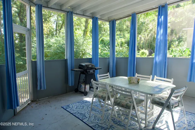 a view of a dining room with furniture window and outside view