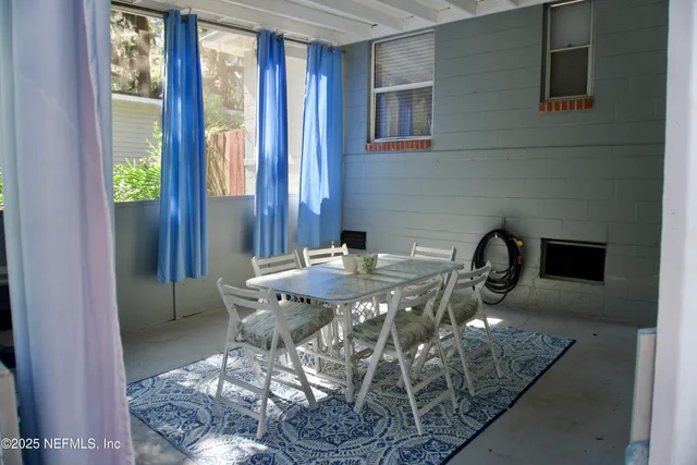 a view of a dining room with furniture window and outside view