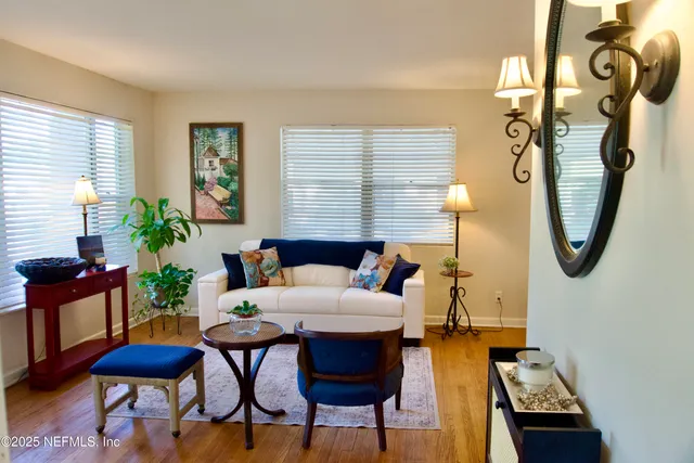 a living room with furniture a window and a chandelier