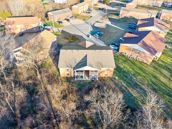 an aerial view of a house with a yard basket ball court and outdoor seating