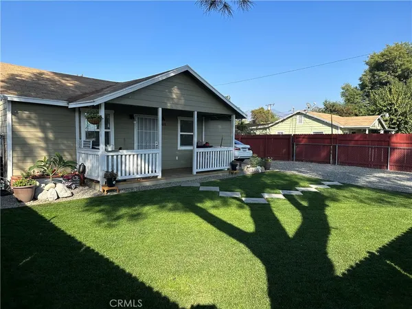 a view of a house with swimming pool and porch with furniture