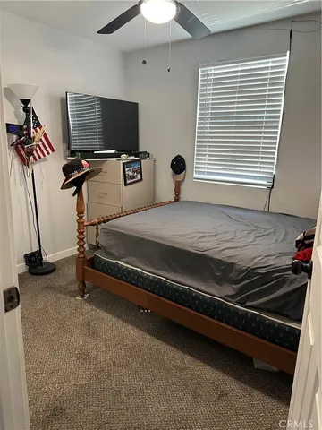 a bed room with a bed and a flat screen tv