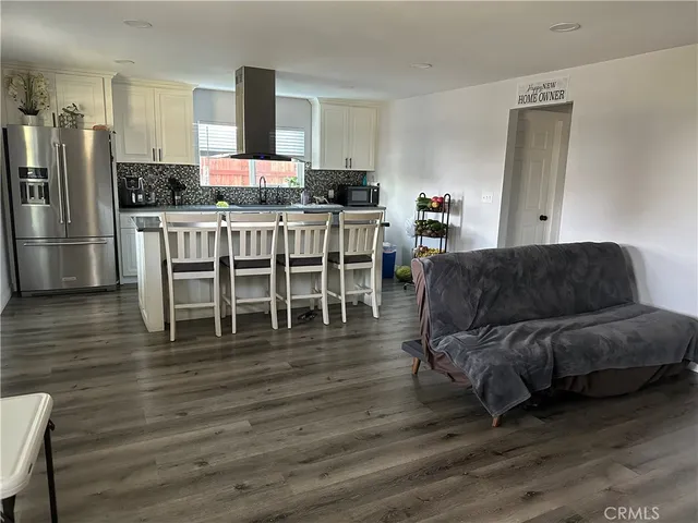 a living room with furniture or kitchen and a wooden floor
