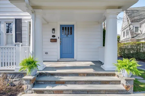 a front view of a house with potted plants