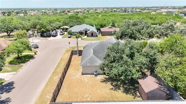 aerial view of a house with a garden and a yard