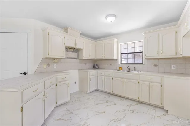 a kitchen with sink cabinets and window