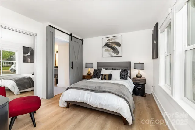 a bedroom with a bed couch and a window