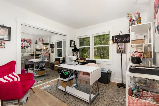 a living room with furniture a window and gym equipment