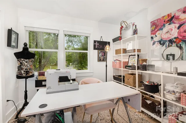 a very nice looking living room with a large window cabinets and a table