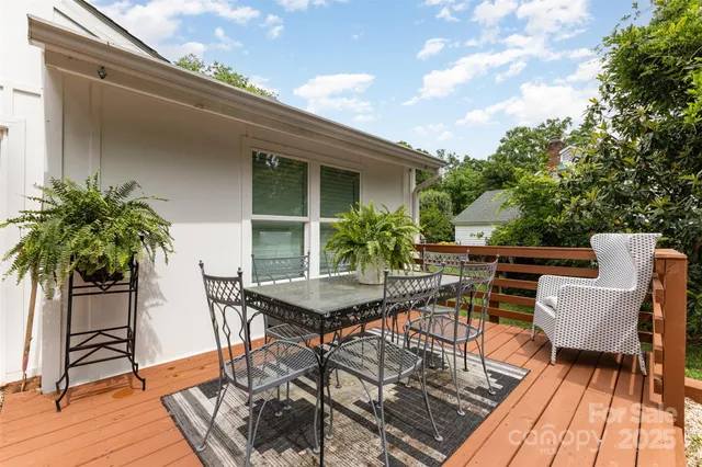 a view of a dinning table and chairs in patio of the house
